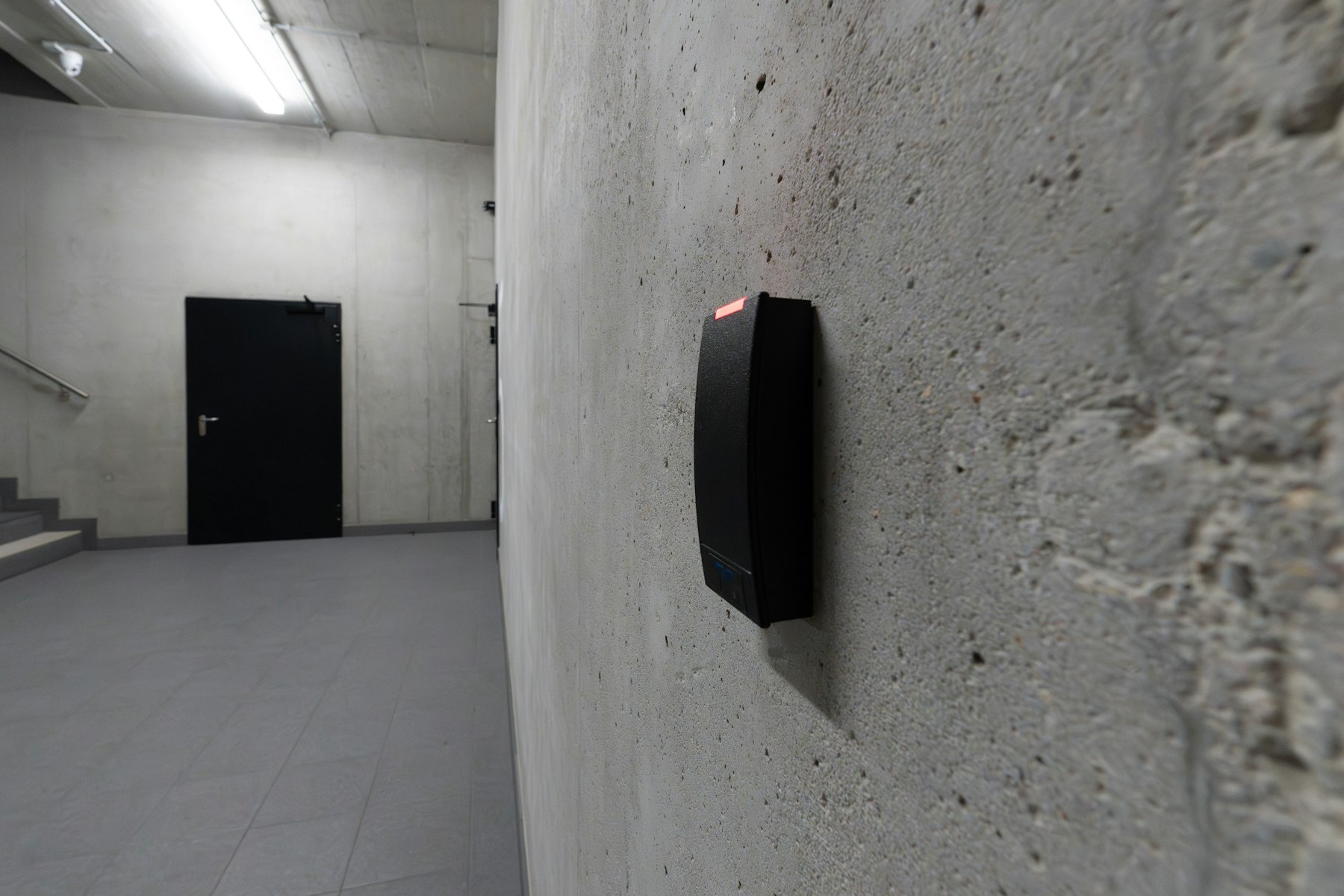 Electronic access-control reader installed beside a secure door